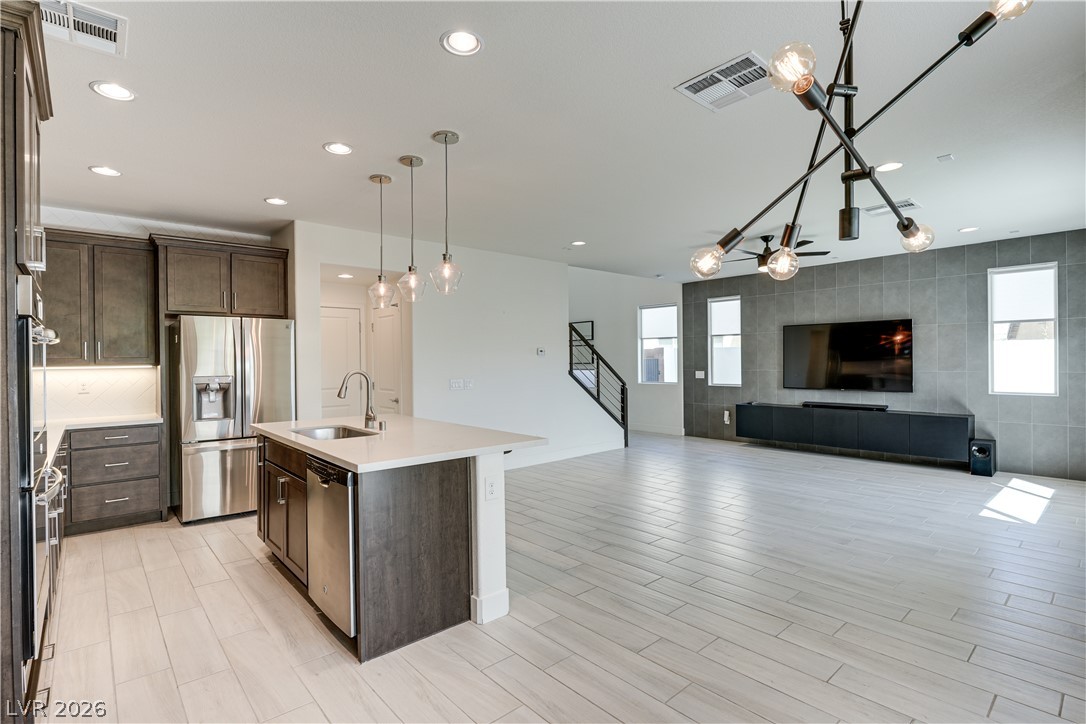 5954 Smith Valley Road Las Vegas, NV 89148 - Photo 2 of 23 An open-concept living space integrates a modern kitchen and a spacious living area, ideal for contemporary living.