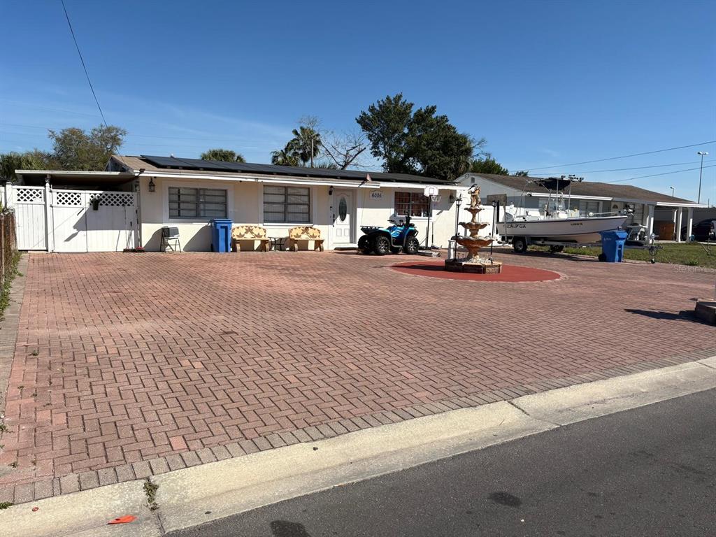 6005 West Clifton Street Tampa, FL 33634 - Photo 1 of 32 a front view of a house with parking area