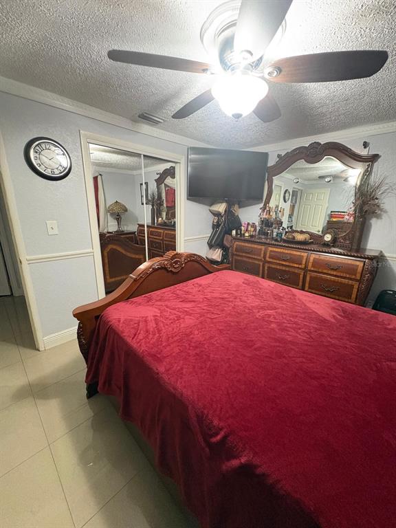 6005 West Clifton Street Tampa, FL 33634 - Photo 11 of 32 a bed sitting in a bedroom next to a larger window