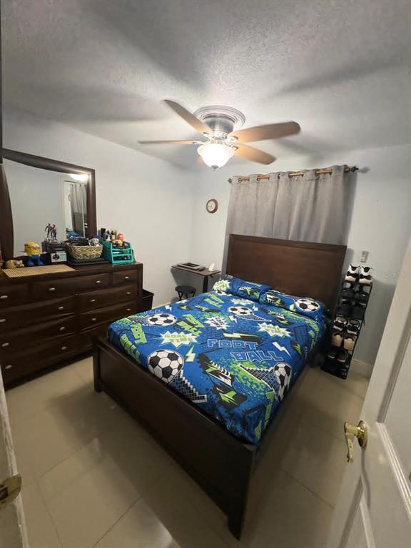 6005 West Clifton Street Tampa, FL 33634 - Photo 14 of 32 a bed sitting in a bedroom next to a window