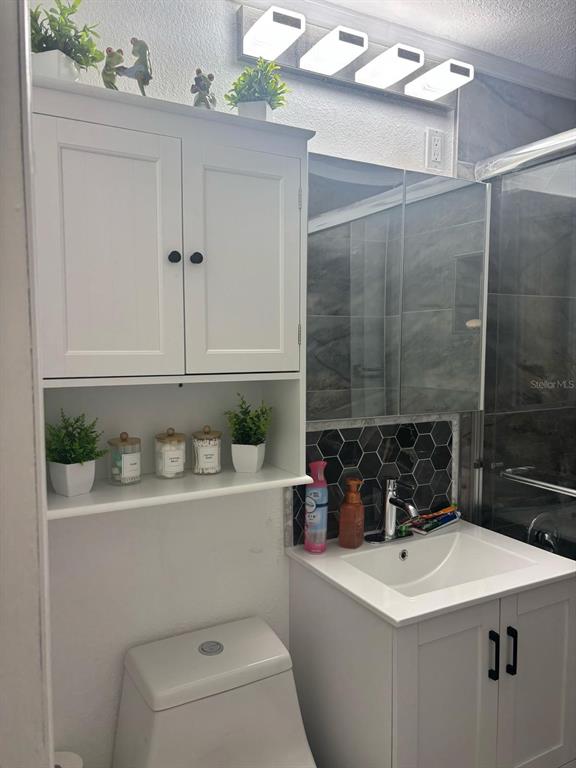 6005 West Clifton Street Tampa, FL 33634 - Photo 15 of 32 a bathroom with a sink a toilet and shower