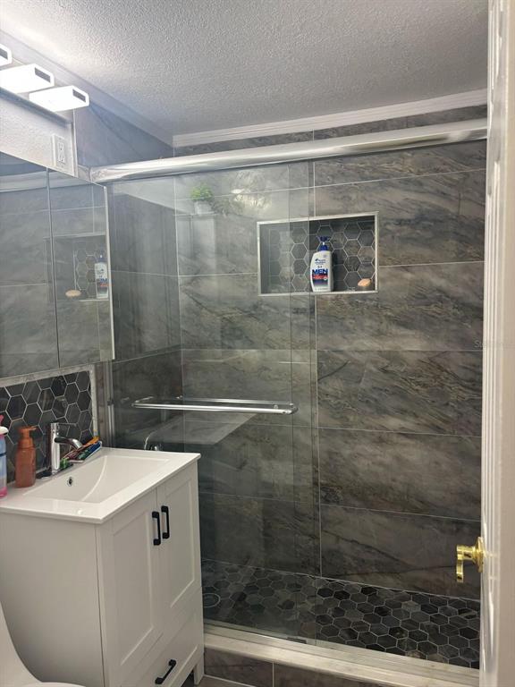 6005 West Clifton Street Tampa, FL 33634 - Photo 16 of 32 a bathroom with a shower and sink