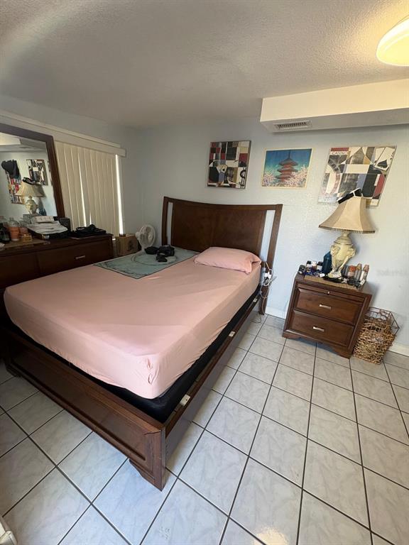 6005 West Clifton Street Tampa, FL 33634 - Photo 18 of 32 a bed room with a bed and a night stand