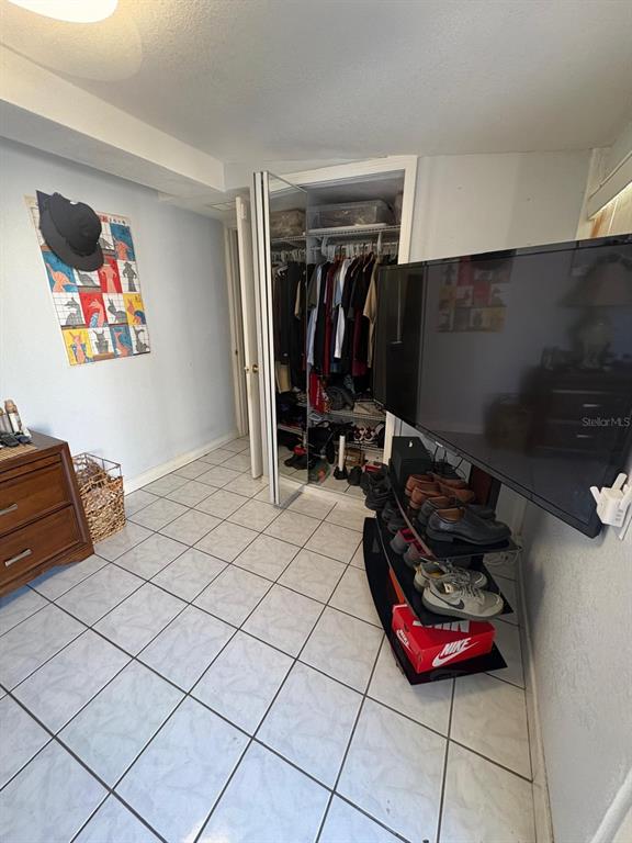 6005 West Clifton Street Tampa, FL 33634 - Photo 20 of 32 a bed room with a bed and a couch