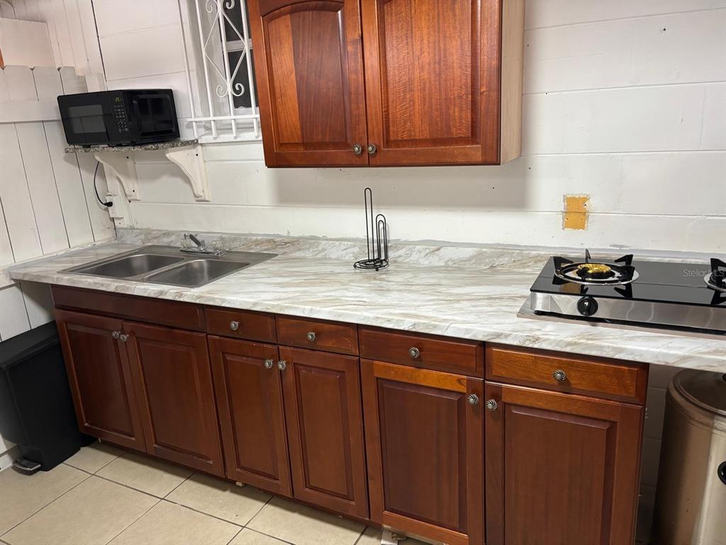 6005 West Clifton Street Tampa, FL 33634 - Photo 21 of 32 a kitchen with a sink and cabinets