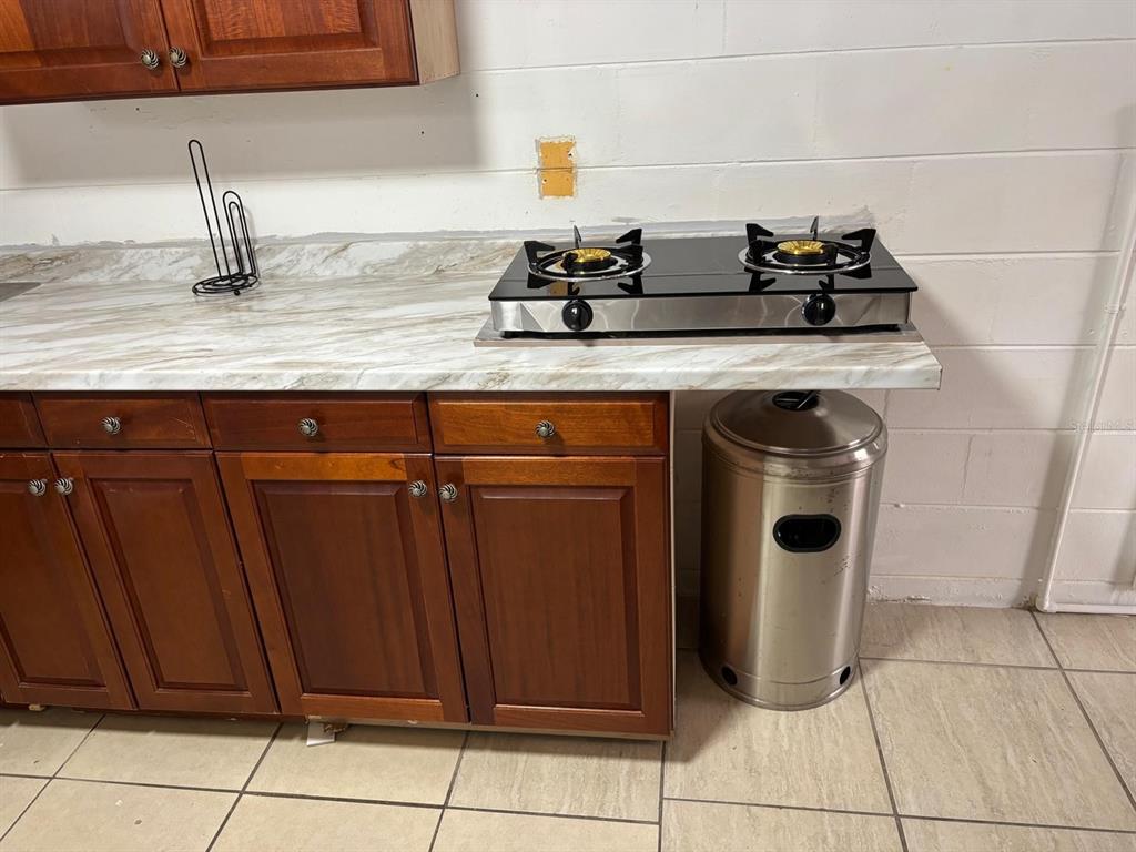 6005 West Clifton Street Tampa, FL 33634 - Photo 22 of 32 a kitchen with granite countertop a sink and a stove