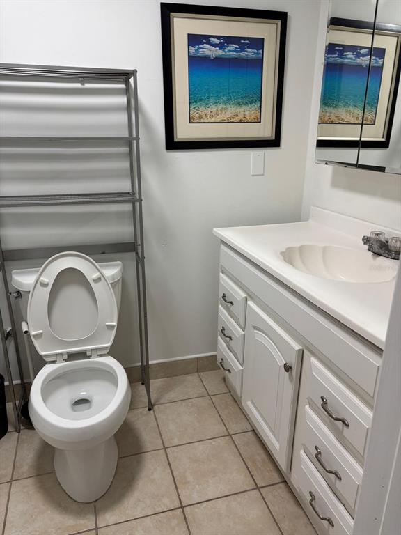 6005 West Clifton Street Tampa, FL 33634 - Photo 23 of 32 a bathroom with a toilet a sink and mirror