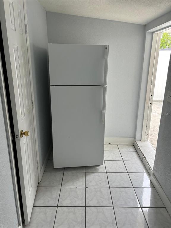 6005 West Clifton Street Tampa, FL 33634 - Photo 29 of 32 a view of a refrigerator in kitchen and an empty room