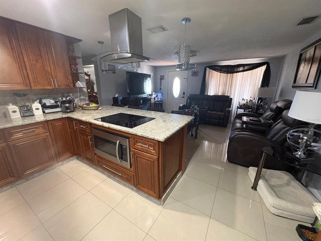 6005 West Clifton Street Tampa, FL 33634 - Photo 6 of 32 a kitchen with a stove sink and cabinets