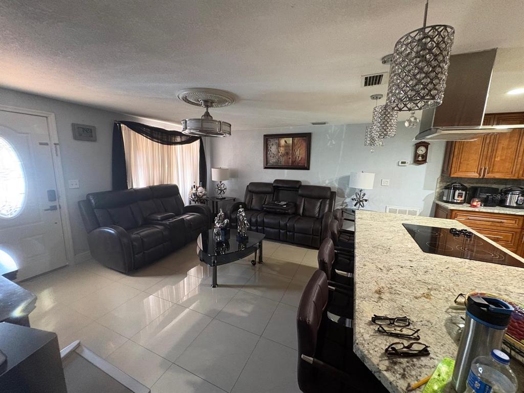 6005 West Clifton Street Tampa, FL 33634 - Photo 8 of 32 a living room with furniture and a flat screen tv