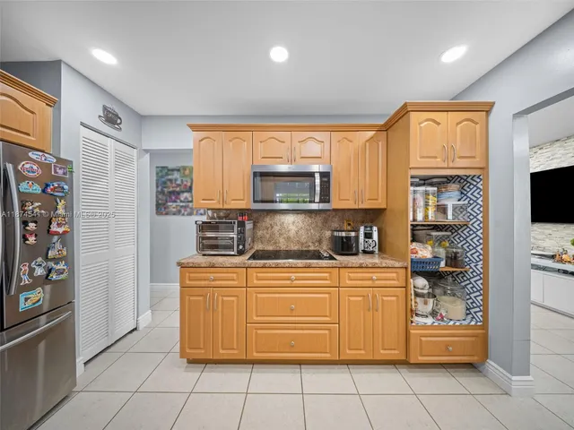 a kitchen with stainless steel appliances granite countertop a stove and a refrigerator