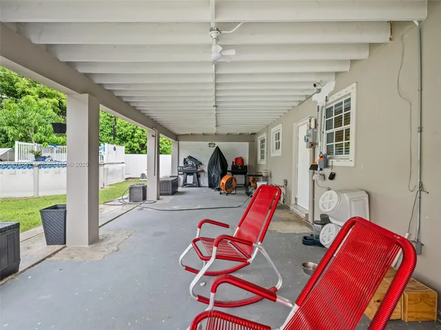 a view of a house with backyard and a sitting area
