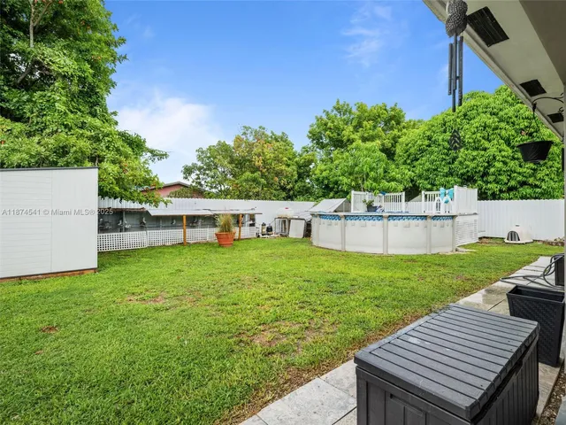 a view of a house with backyard sitting area and tub