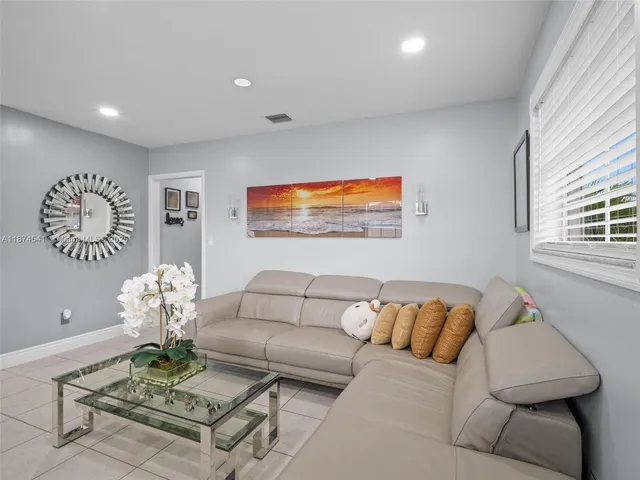 a living room with furniture flowerpot and a window