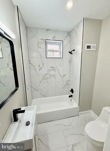 a bathroom with a bathtub sink and toilet