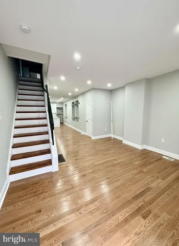 a view of a room with stairs and wooden floor