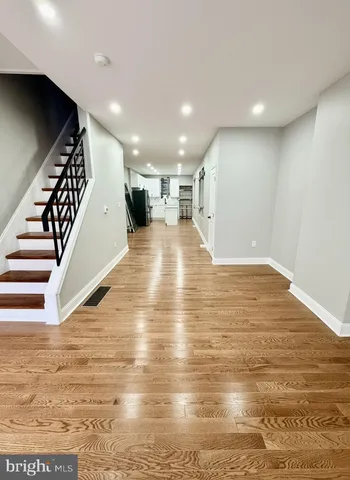 a view of a room with wooden floor