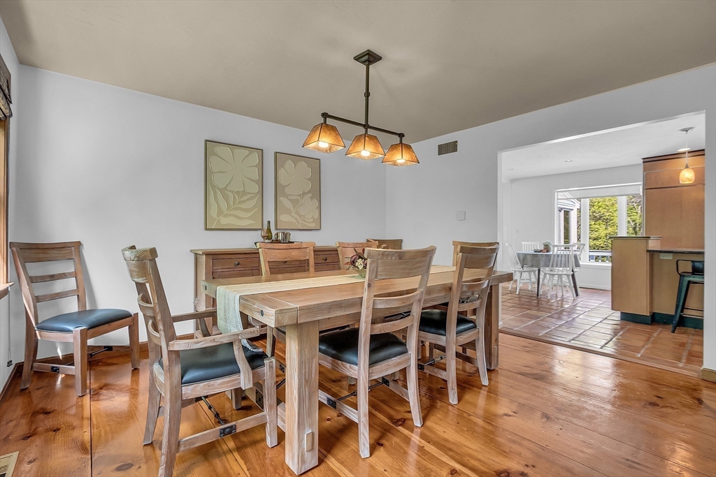 16 Bulette Road Acton, MA 01720 - Photo 12 of 42 a dining room with furniture wooden floor a rug and a chandelier