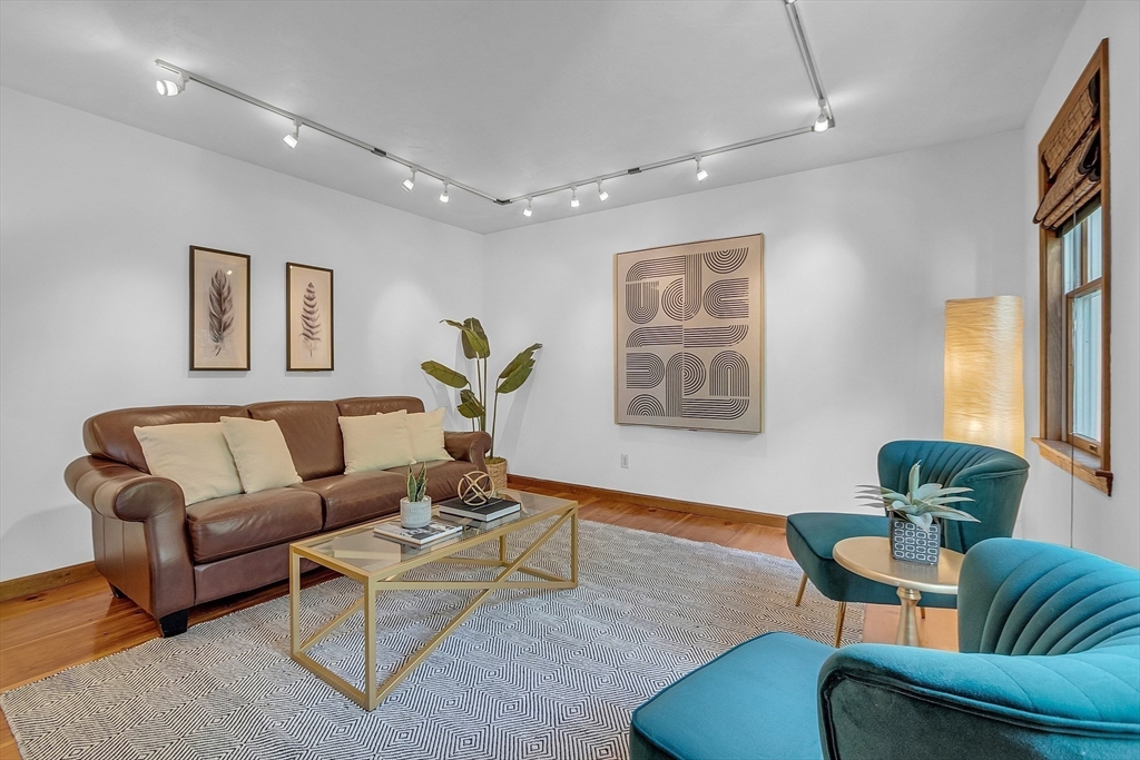 16 Bulette Road Acton, MA 01720 - Photo 17 of 42 a living room with furniture and a potted plant