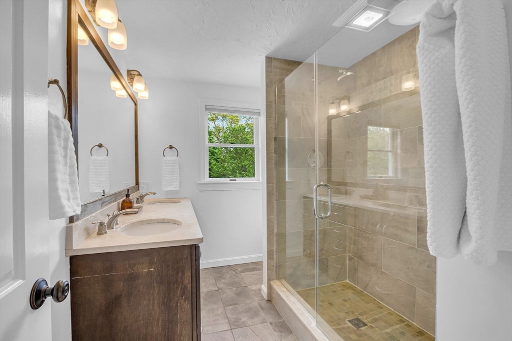 16 Bulette Road Acton, MA 01720 - Photo 24 of 42 a bathroom with a sink a mirror and a shower