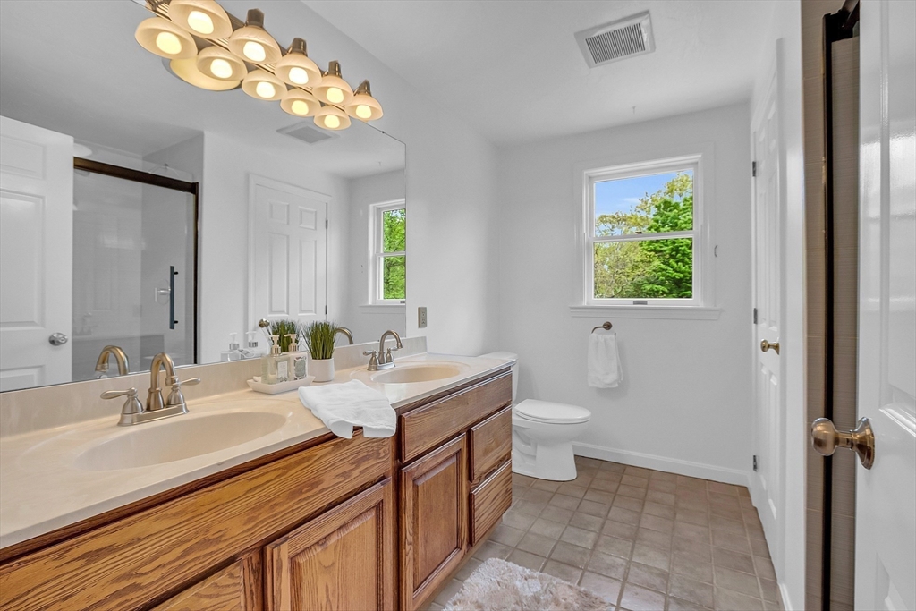 16 Bulette Road Acton, MA 01720 - Photo 28 of 42 a bathroom with a double vanity sink and a mirror