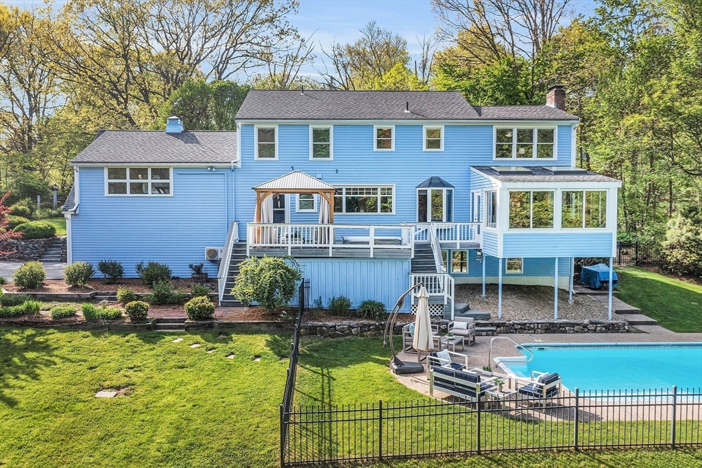 16 Bulette Road Acton, MA 01720 - Photo 37 of 42 a front view of a house with swimming pool table and chairs