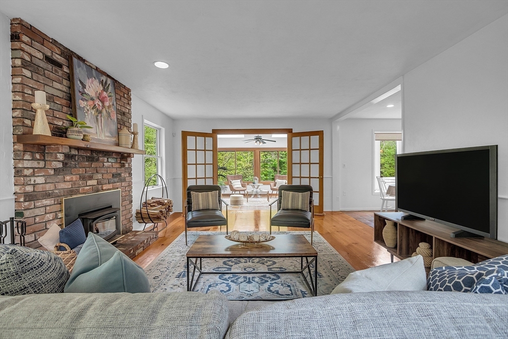 16 Bulette Road Acton, MA 01720 - Photo 5 of 42 a living room with fireplace furniture and a flat screen tv