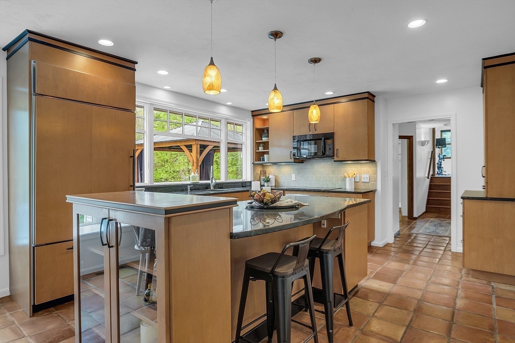 16 Bulette Road Acton, MA 01720 - Photo 7 of 42 a kitchen with stainless steel appliances granite countertop a sink a stove and a refrigerator