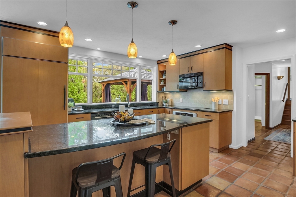 16 Bulette Road Acton, MA 01720 - Photo 8 of 42 a kitchen with stainless steel appliances granite countertop a sink and a refrigerator