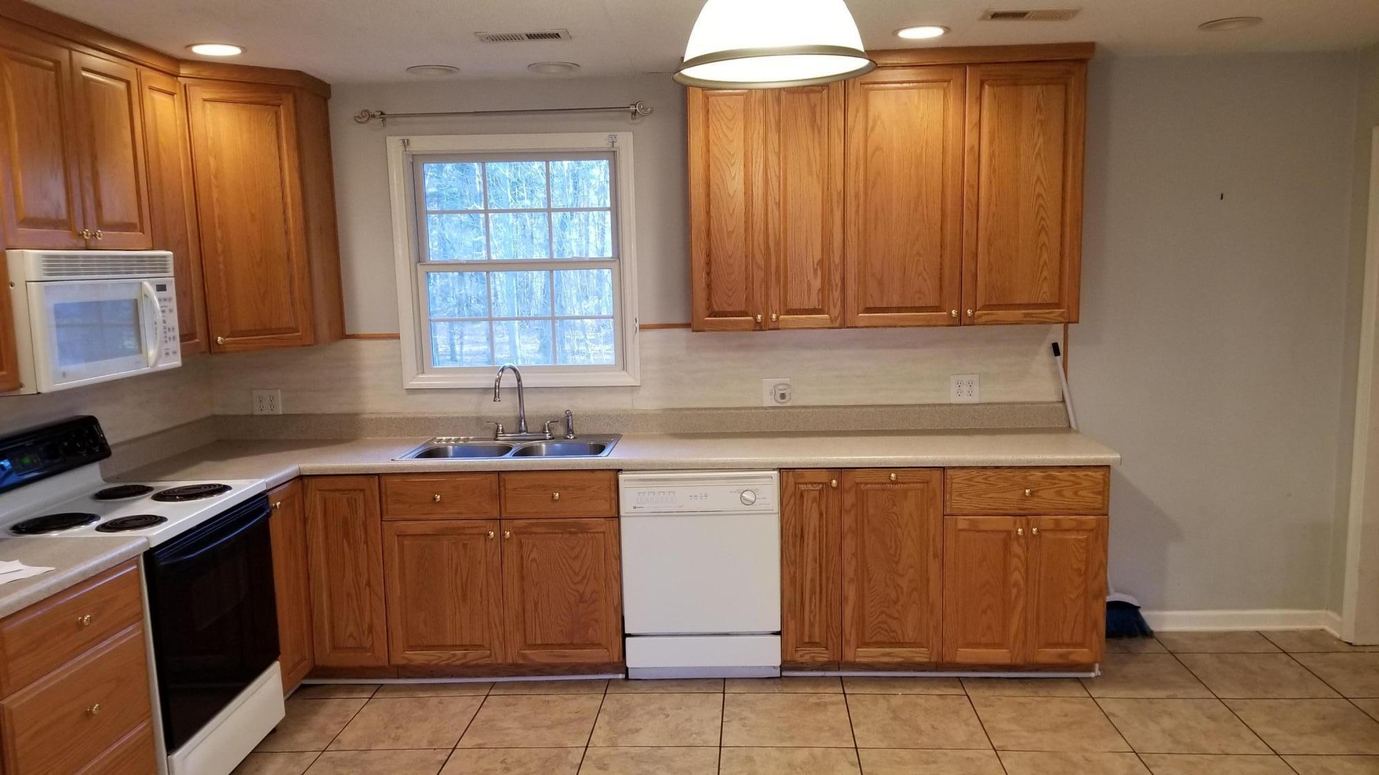 110 Foggy Ridge Road Rocky Mount, VA 24151 - Photo 4 of 35 a kitchen with stainless steel appliances granite countertop a stove a sink and a microwave