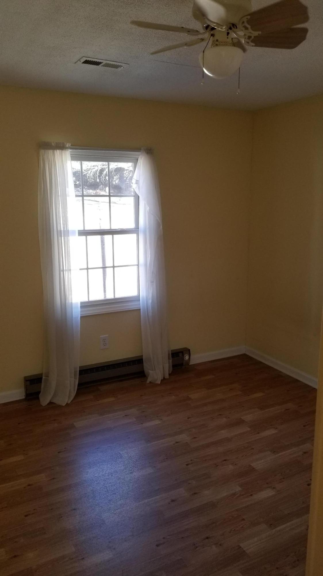 110 Foggy Ridge Road Rocky Mount, VA 24151 - Photo 10 of 35 an empty room with wooden floor and windows