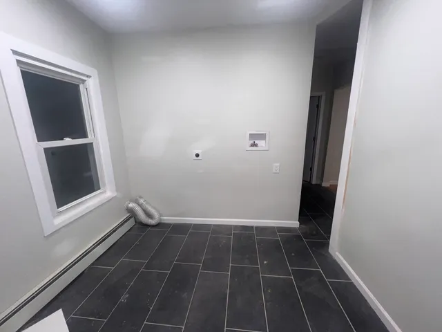 a view of a room with wooden floor and white walls