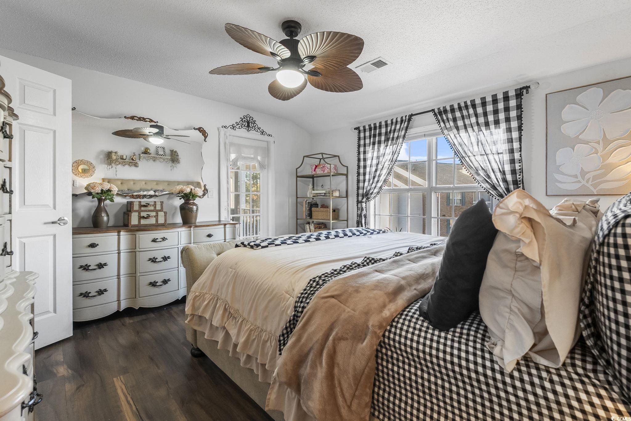 3753 Citation Way, Unit 438 Myrtle Beach, SC 29577 - Photo 18 of 33 Bedroom with multiple windows, dark wood-style floors, a textured ceiling, and ceiling fan
