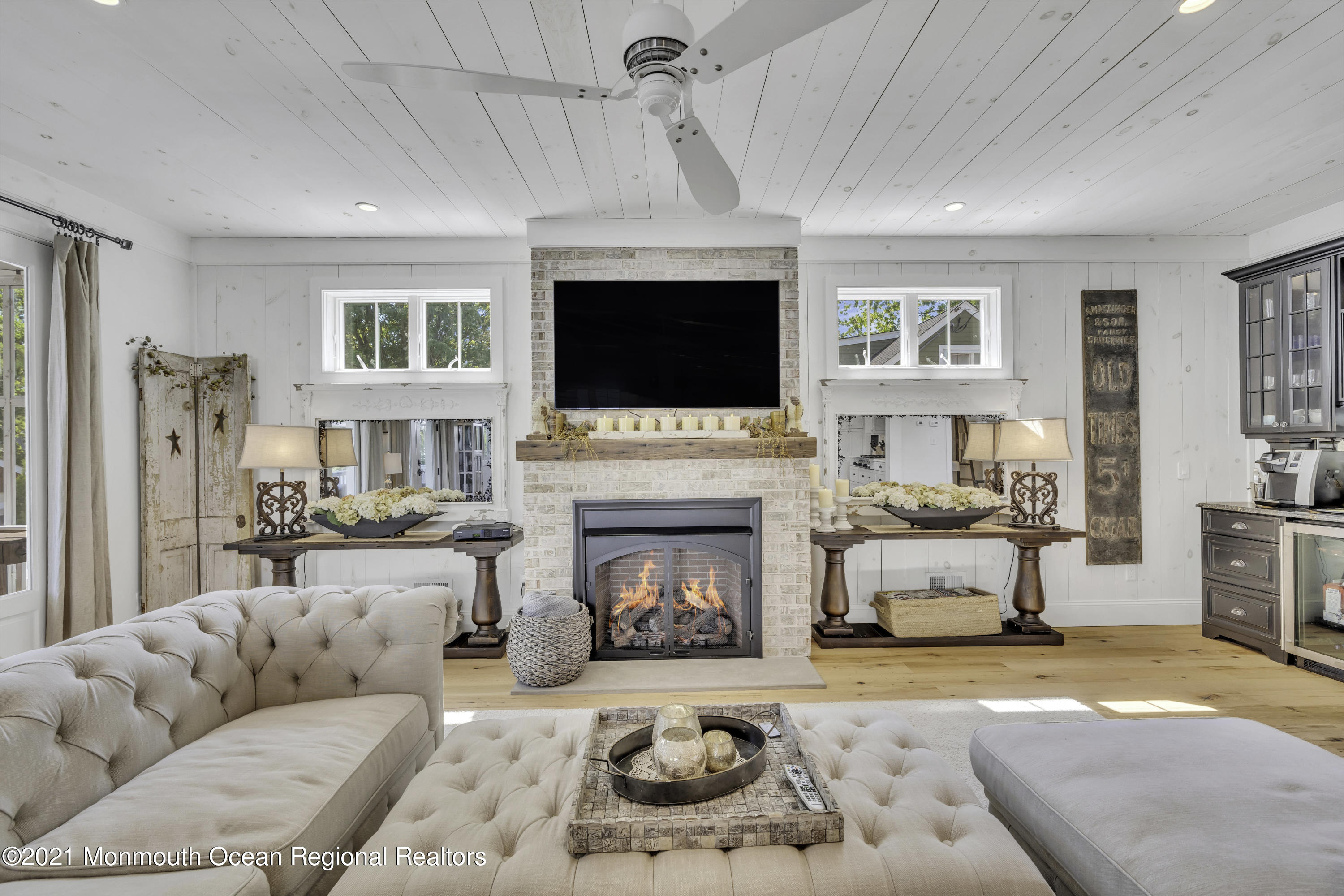 52 Marcellus Avenue Manasquan, NJ 08736 - Photo 19 of 79 a living room with furniture a flat screen tv and a fireplace