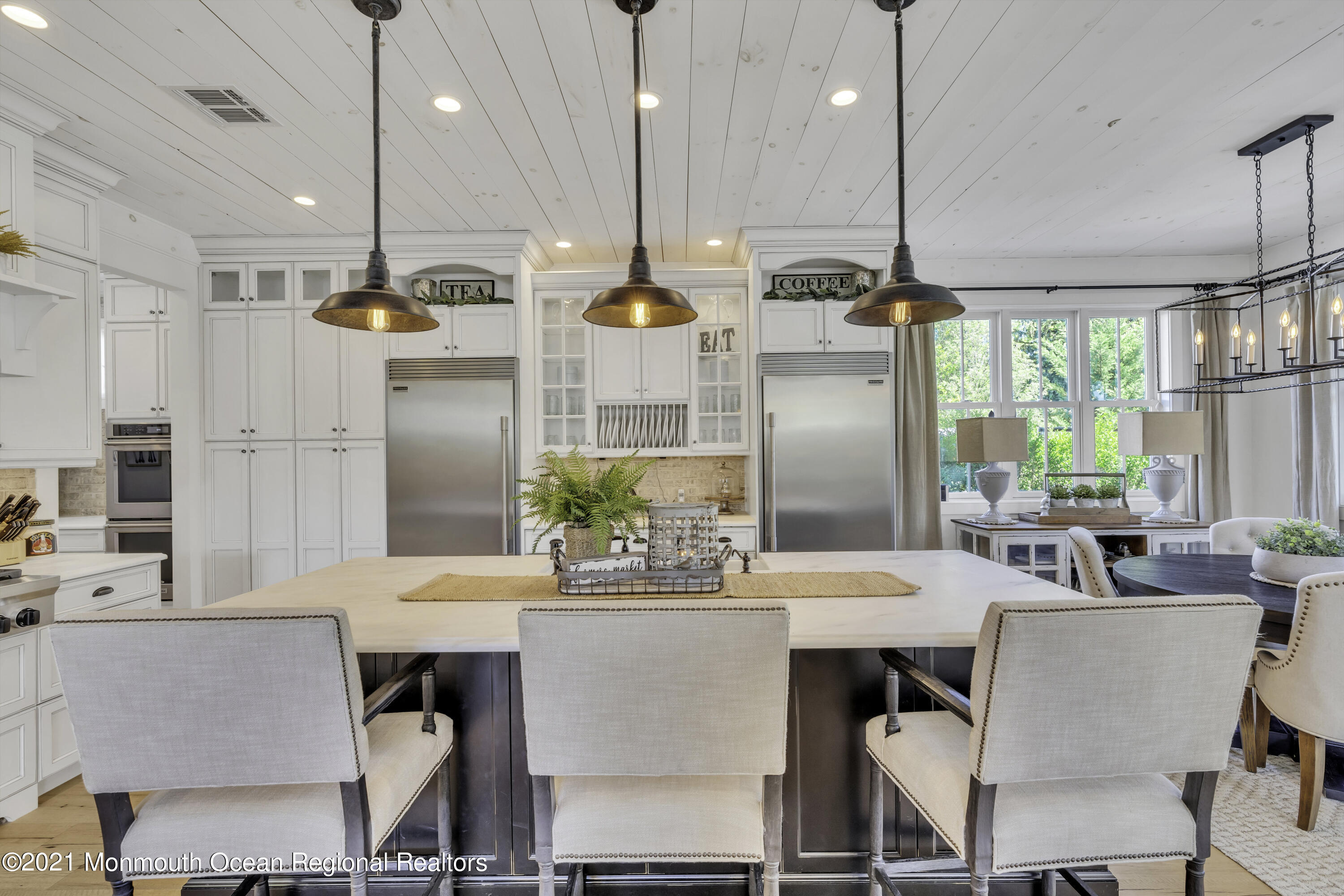 52 Marcellus Avenue Manasquan, NJ 08736 - Photo 23 of 79 a kitchen with stainless steel appliances kitchen island granite countertop a table chairs and a sink