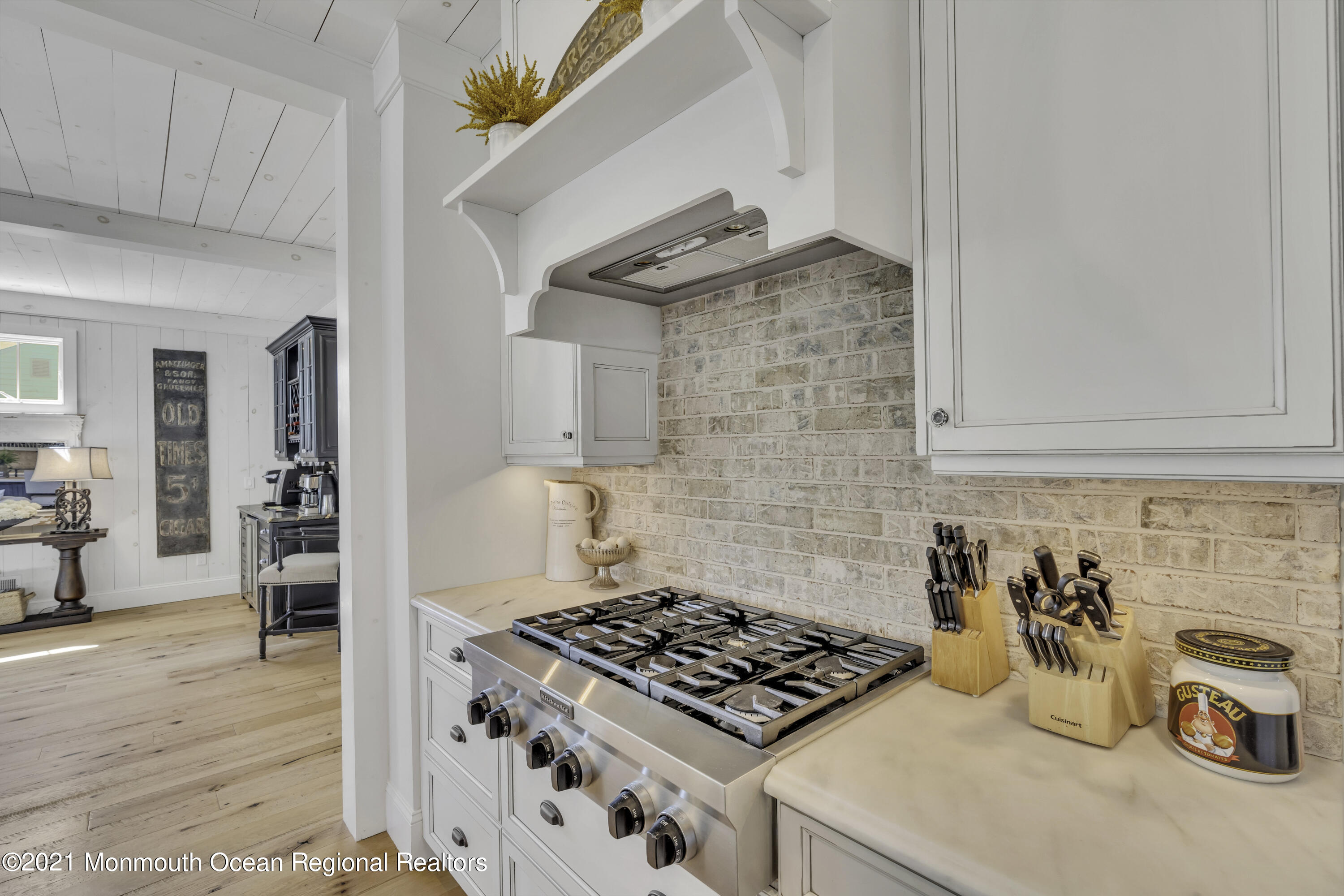 52 Marcellus Avenue Manasquan, NJ 08736 - Photo 29 of 79 a kitchen with granite countertop a stove and a wooden cabinets