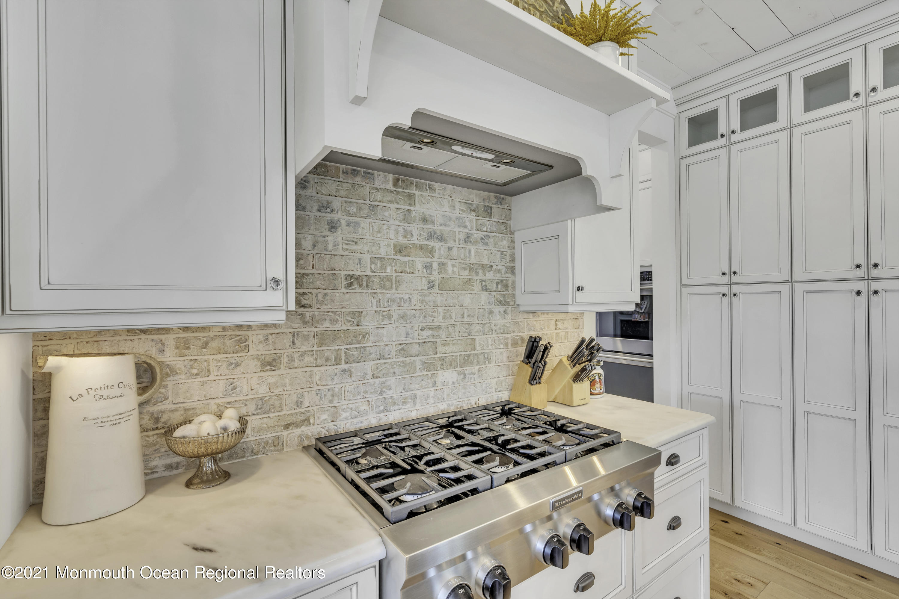 52 Marcellus Avenue Manasquan, NJ 08736 - Photo 30 of 79 a kitchen with a stove and a cabinet