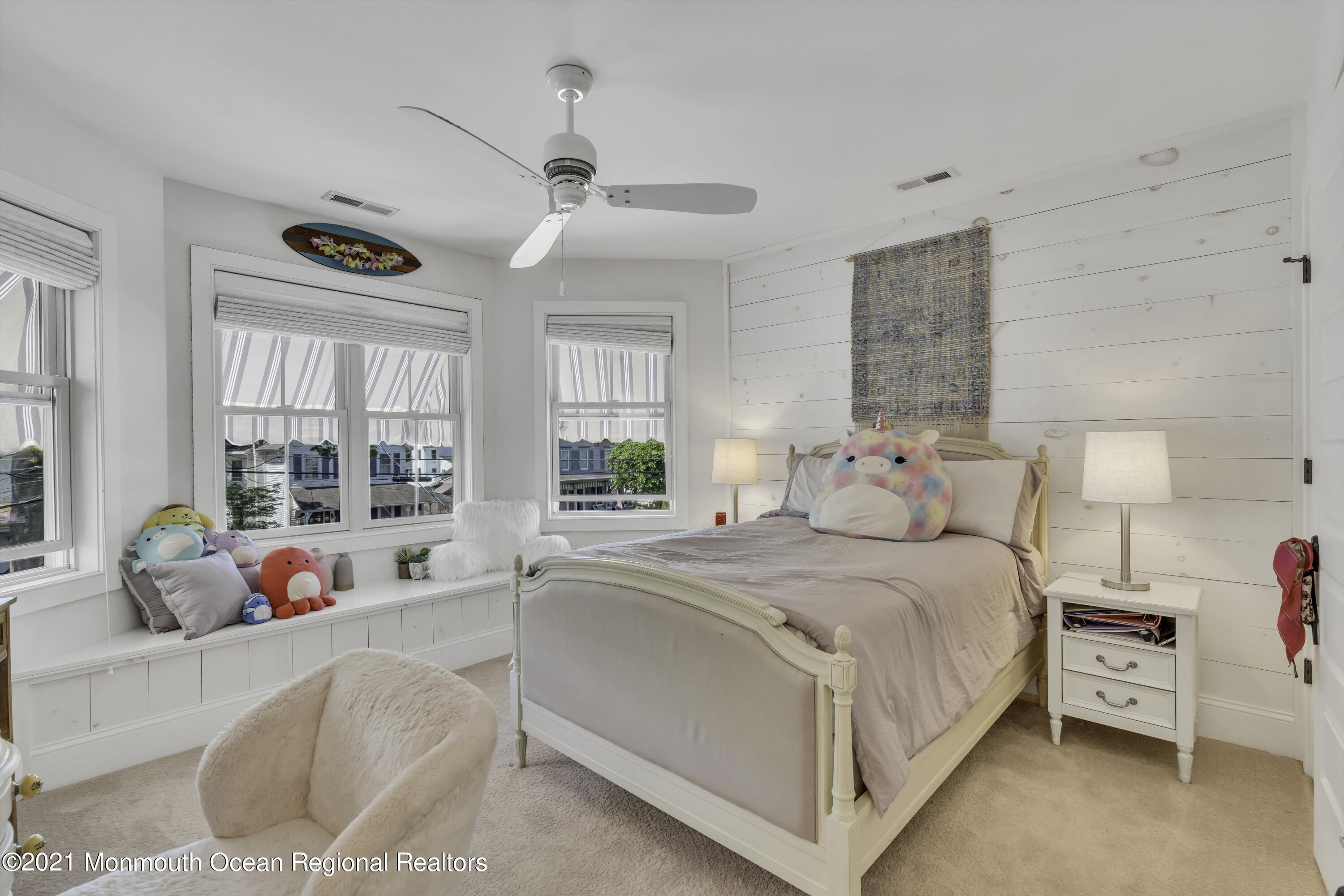 52 Marcellus Avenue Manasquan, NJ 08736 - Photo 49 of 79 a bedroom with a bed and large windows