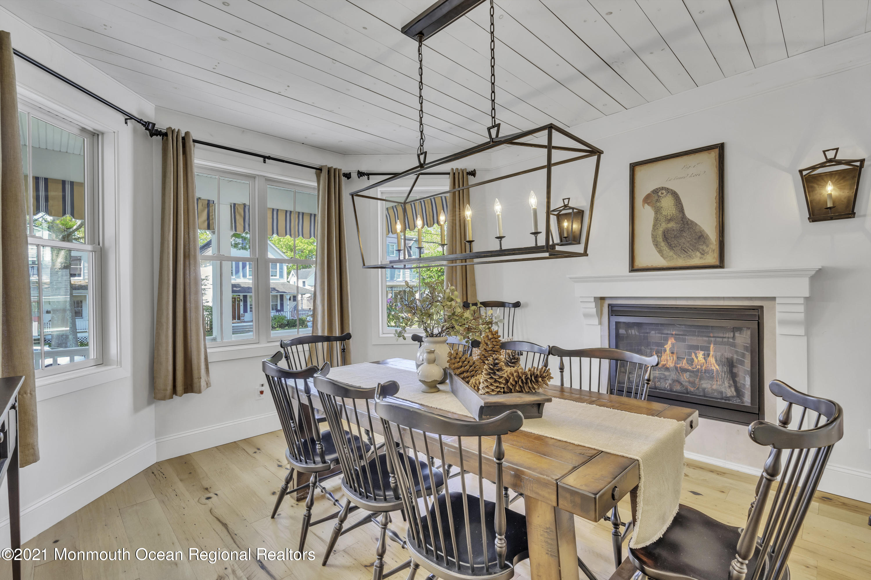 52 Marcellus Avenue Manasquan, NJ 08736 - Photo 9 of 79 a dining room with furniture a floor to ceiling window and potted plants