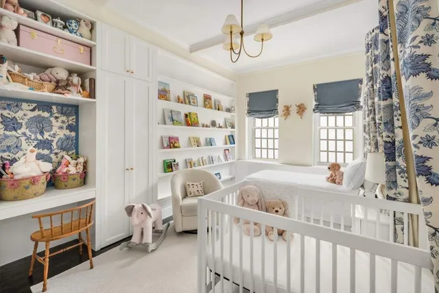 a bedroom with furniture and a large window