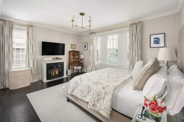 a spacious bedroom with a bed and a flat screen tv