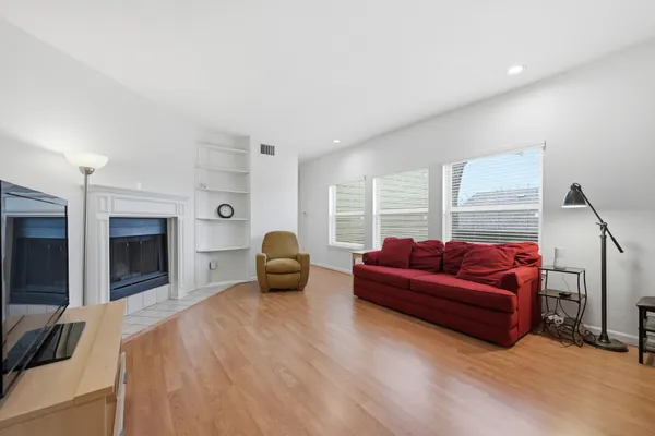 a living room with furniture a fireplace and a flat screen tv