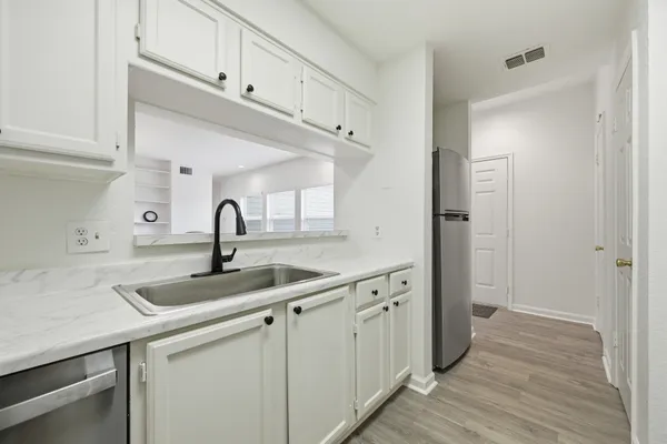 a kitchen with a sink and cabinets