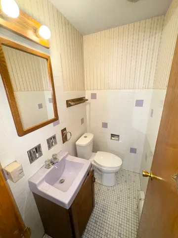 a bathroom with a sink toilet and mirror
