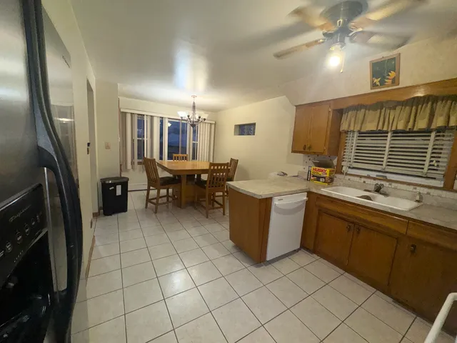 a kitchen with a sink appliances and cabinets