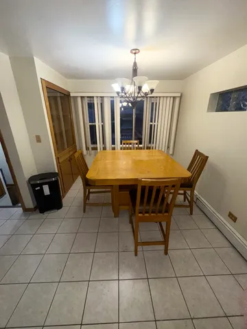 a dining room with furniture and chandelier