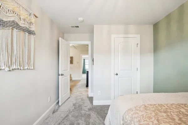 a bedroom with a bed and a bathroom