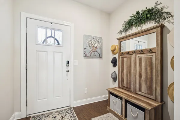 a view of an entryway with wooden floor