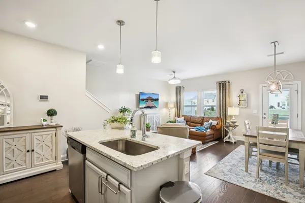 a kitchen with a sink a counter and chairs