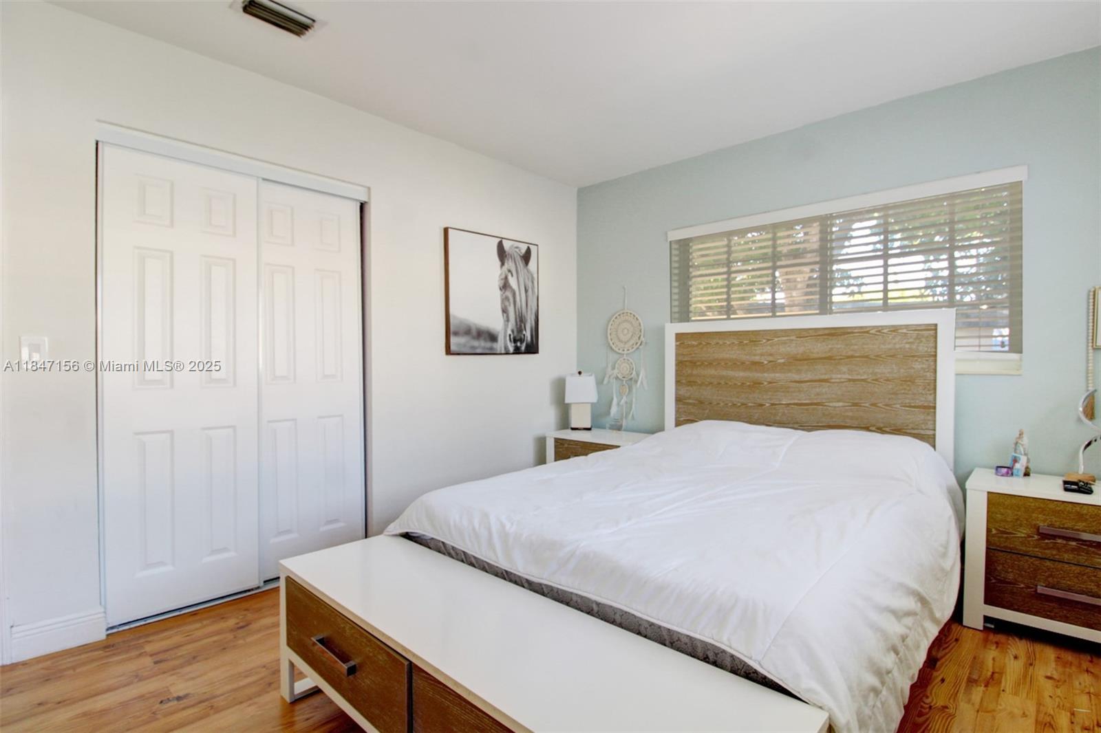 9755 Southwest 161st Street Miami, FL 33157 - Photo 16 of 32 a bedroom with a bed and a window